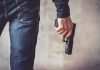 Illegal Opens FIRE on Homeless Camp person holding a handgun by their side