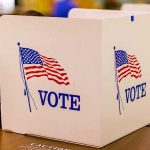 Democrats SPLIT Over Their Own Senate Pick voting booth with American flag graphics