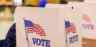 Democrats SPLIT Over Their Own Senate Pick voting booth with American flag graphics