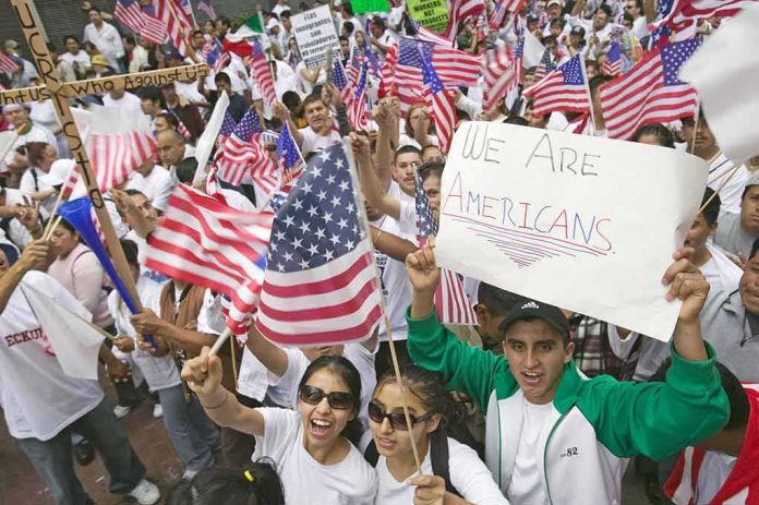 shutterstock_107261690-3 Josh Boyce and crowd at a demonstration waving American flags