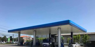 Gas Station DRUG Tied to College Student Deaths Gas station canopy with fuel pumps and vehicles on a clear day