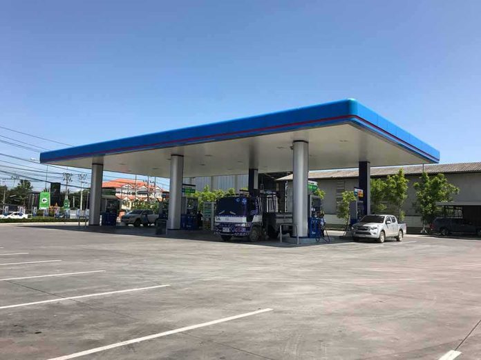 shutterstock_1092730340 Gas station canopy with fuel pumps and vehicles on a clear day