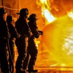 Soldiers Lost in Fast-Moving Base FIRE Firefighters battling a large blaze with a hose