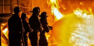 Soldiers Lost in Fast-Moving Base FIRE Firefighters battling a large blaze with a hose