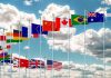 This Country’s Voter Roll Fight Sends Gen Z Into the Streets Row of international flags on tall poles against a cloudy sky