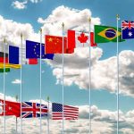 This Country’s Voter Roll Fight Sends Gen Z Into the Streets Row of international flags on tall poles against a cloudy sky