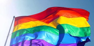 Jesuits REJECT Man Who Questioned LGBT Priest Rainbow pride flag waving against a clear blue sky