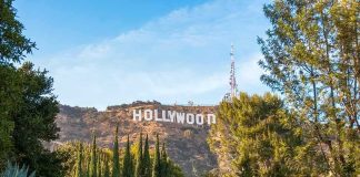 Hollywood Money Is FLEEING America Hollywood Sign on hillside framed by trees