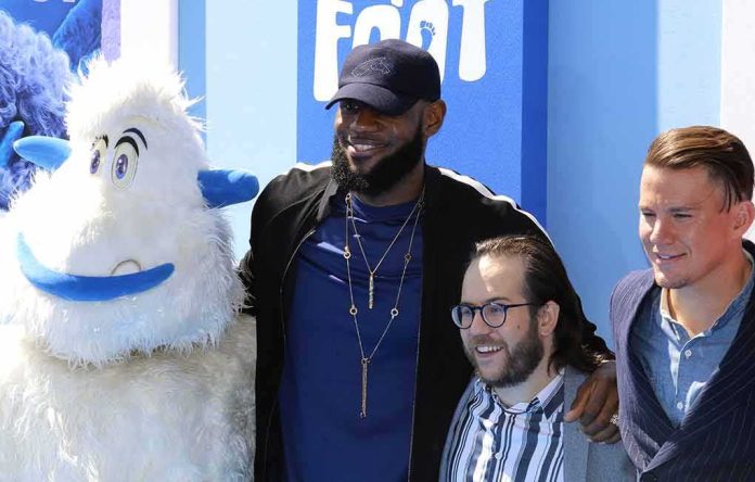 shutterstock_1185842647 LeBron James and Channing Tatum pose with a mascot and another attendee
