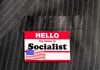GOP Warns Michigan Could Go SOCIALIST Name tag on a pinstripe suit jacket pocket