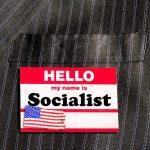 GOP Warns Michigan Could Go SOCIALIST Name tag on a pinstripe suit jacket pocket