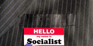 GOP Warns Michigan Could Go SOCIALIST Name tag on a pinstripe suit jacket pocket