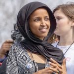 Feds Left Ilhan Omar Unable to Phone HOME Ilhan Omar wearing a black headscarf at an outdoor event