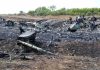 Mamdani’s Wife’s Olive Oil Bottles Feature Terrorist HIJACKER Airplane crash debris scattered across a burned field