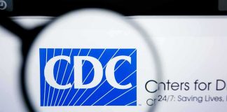 Trump’s CDC Urges New COVID Shot Magnifying glass over CDC logo on a computer screen