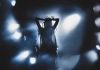 Bush-Bashing Singer Now Goes After TRUMP Silhouetted singer on stage amid dramatic blue spotlights