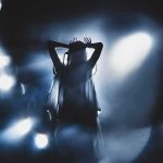 Bush-Bashing Singer Now Goes After TRUMP Silhouetted singer on stage amid dramatic blue spotlights