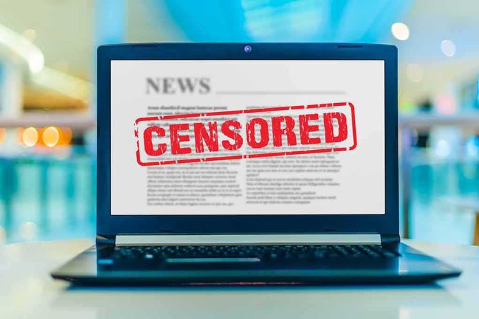 shutterstock_1715215150 Laptop displaying censored news article