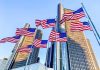 Iconic Chrysler Building Finally SOLD American flags waving before modern glass skyscrapers
