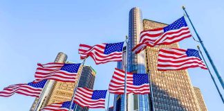 Iconic Chrysler Building Finally SOLD American flags waving before modern glass skyscrapers