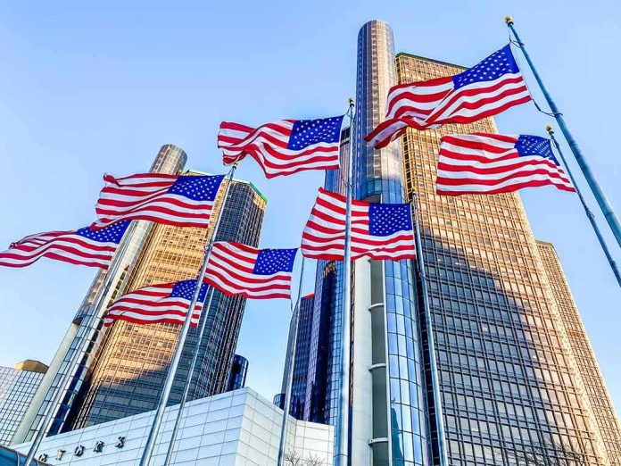 shutterstock_1764861611 American flags waving before modern glass skyscrapers