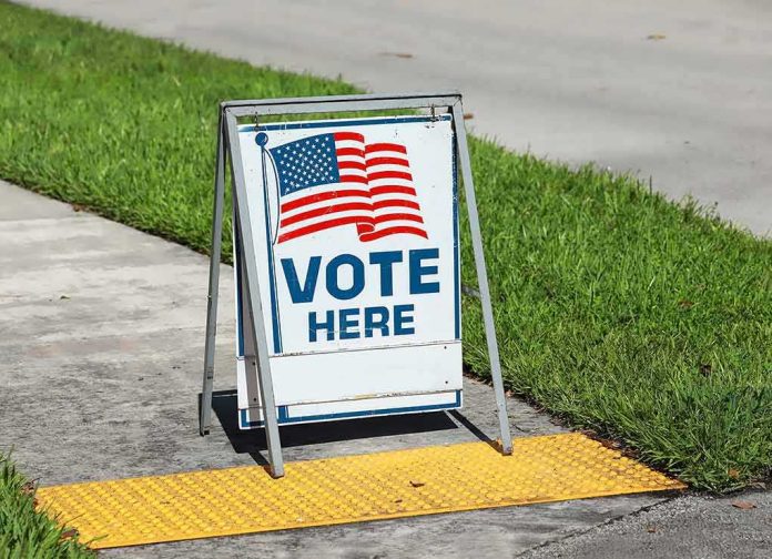 shutterstock_1798423933 A-frame sidewalk sign with American flag and vote message