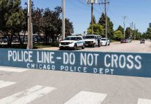 Congress Says Illinois Let 500 Migrants WALK Police line barrier blocking a street with patrol vehicles behind