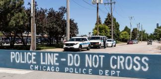 Congress Says Illinois Let 500 Migrants WALK Police line barrier blocking a street with patrol vehicles behind