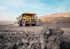 They’re Drilling Into ‘Noah’s ARK’ Mining haul truck driving through an open-pit mine