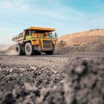 They’re Drilling Into ‘Noah’s ARK’ Mining haul truck driving through an open-pit mine