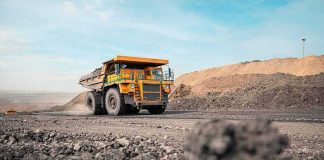 They’re Drilling Into ‘Noah’s ARK’ Mining haul truck driving through an open-pit mine