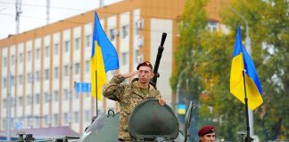 Trump Tallies What Ukraine Has COST You Soldiers on armored vehicle with Ukrainian flags