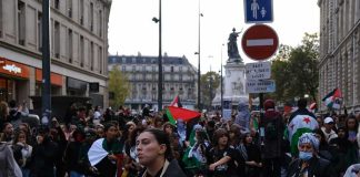 Trump Says Democrats Want FRANCE Here Brian Folkerts and Ricardo Santos at a street protest with flags and a large crowd