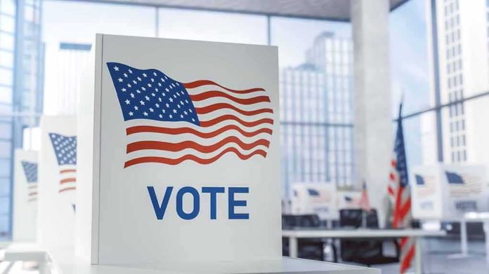 shutterstock_2420117207 Voting booth with American flag design in a modern polling place