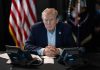 Why Trump’s Ukraine Instincts Could Be RIGHT Donald Trump seated at a table between two desk phones