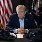 Why Trump’s Ukraine Instincts Could Be RIGHT Donald Trump seated at a table between two desk phones