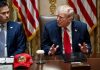 Donald Trump speaks at a meeting table beside Marco Rubio