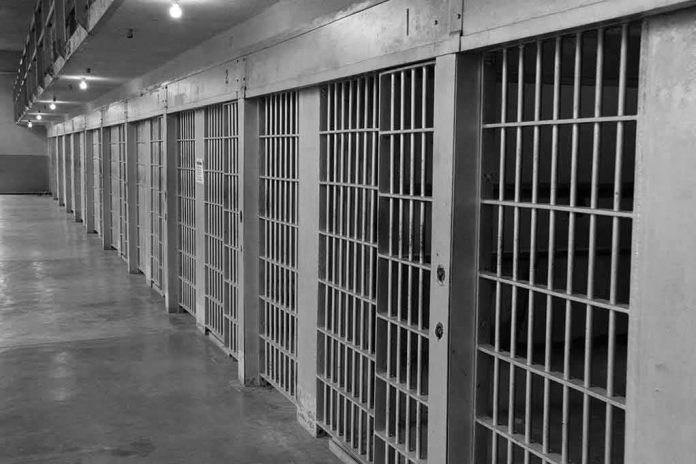 Row of prison cells with barred doors