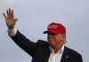 Trump Will Pay You For SNITCHING Donald Trump waving in a red cap