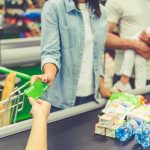 Your Tax Dollars Stolen in Food Stamp FRAUD Customer paying with a card at a supermarket checkout