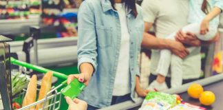Customer paying with a card at a supermarket checkout