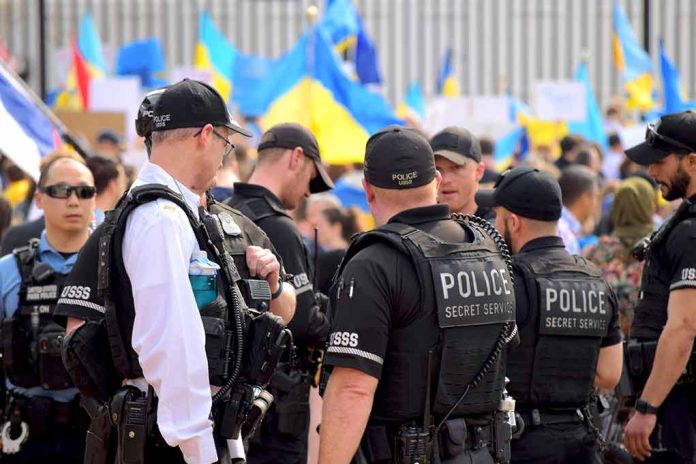2132863557 featured image Police officers gathered near a crowd with flags.