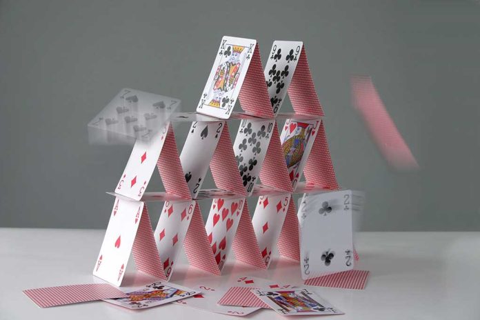 2130029 featured image Collapsing house of cards in motion.