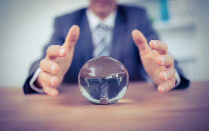 303688010 featured image Man in suit reaching for crystal ball