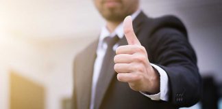 Person in suit giving thumbs up
