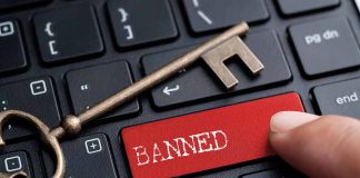 Banned button on keyboard with a skeleton key.