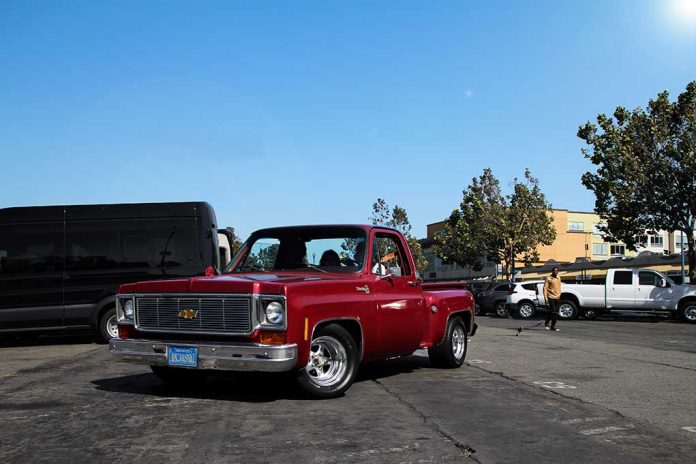 713777041 featured image Red vintage truck parked in sunny urban setting