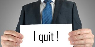 Person holding a sign saying I quit