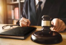 Person in suit with gavel at desk