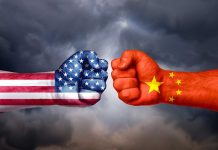 Two fists painted as USA and China flags